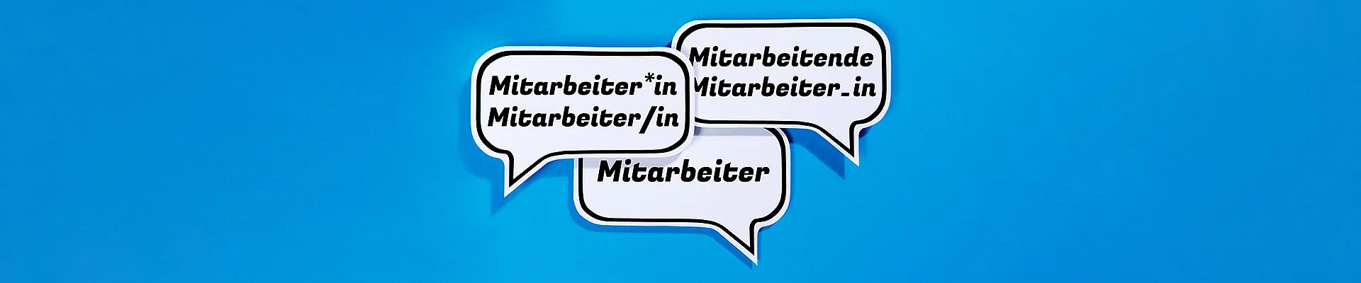 Drei Sprechblasen mit verschieden gegenderten Varianten des Wortes „Mitarbeiter“